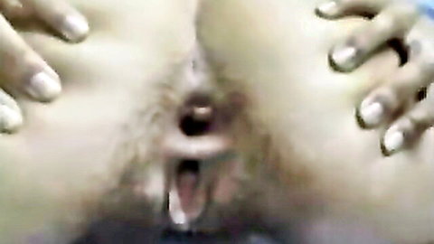 Hairy pussy spread wide open by fingers exposing wet pink vagina