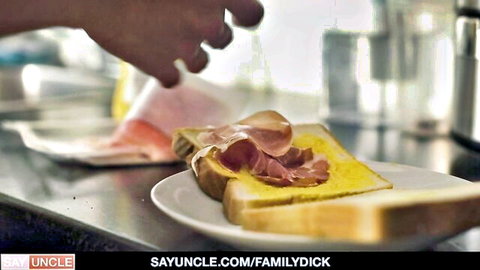 Dark-skinned hand prepares ham sandwich in kitchen for stepdaddy scene