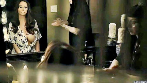 Ava Addams in low-cut dress showing big cleavage, intense mirror gaze