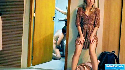 Blonde Scarlet in short floral dress watches naked man kneel in fetish scene
