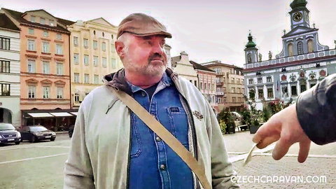 Mature bearded man in Czech town square offered kebab outdoors