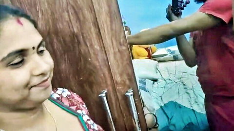 Smiling Indian MILF in colorful saree filmed by young woman in amateur setup
