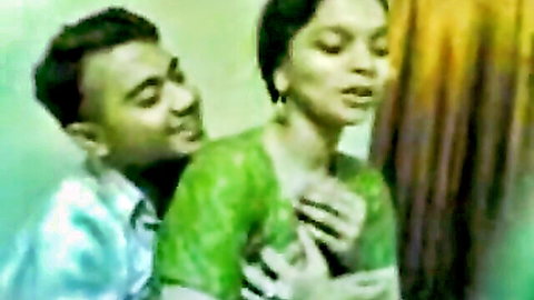 Desi girl in green sari groped from behind by man in seduction scene