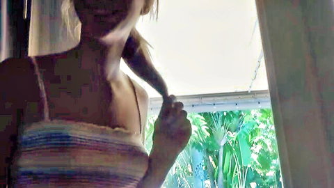 Ana Rose blonde teen in striped bandeau top smiling seductively by window