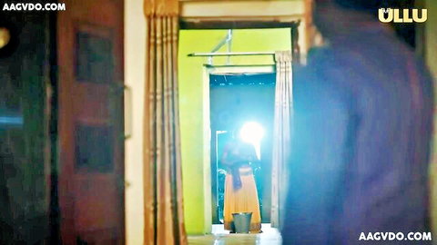 Indian woman in yellow saree holding bucket in doorway, UllU hot series tease