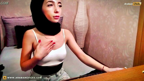 Arab stunner in hijab teases with hand on chest in white tank top on webcam