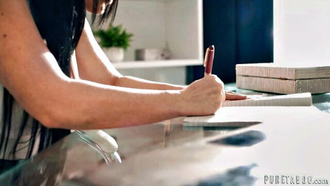 Elegant Asian brunette in white top writing seductively at desk