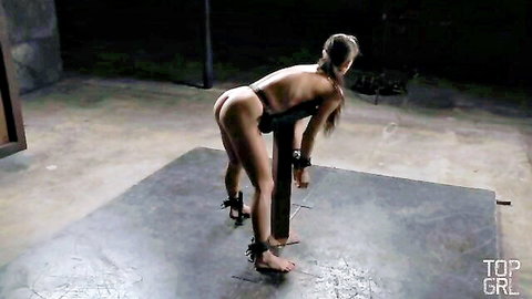 Skinny exotic brunette bound in BDSM pose, hands tied, teased