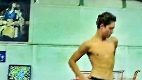 Handsome shirtless brunette hunk with short hair showing muscular abs and toned body