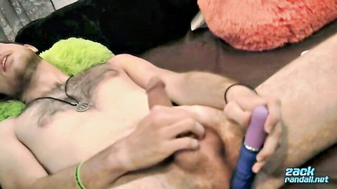 Hairy young man strokes hard cock while inserting purple vibrator into ass solo