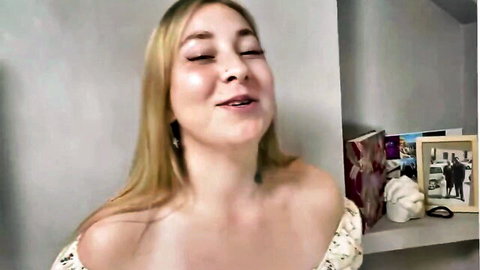 Blonde MILF teases in off-shoulder top smiling seductively