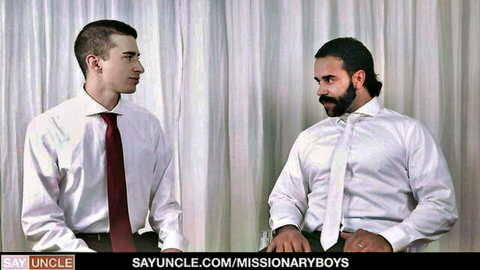 Suited bearded daddy and twink in white shirts staring intensely before gay missionary fuck
