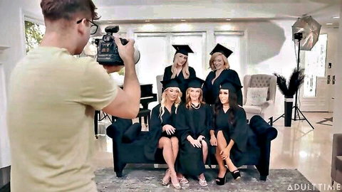 Group of busty MILFs in graduation caps and gowns posing seductively for a photo shoot