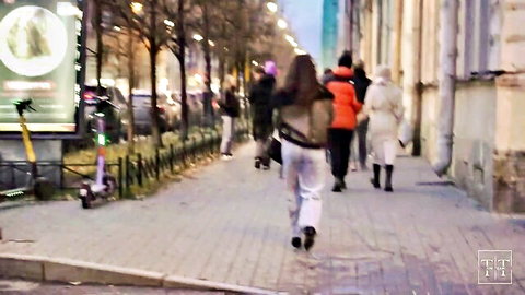 Young college girl in white pants walking public street at night, raw outdoor tease