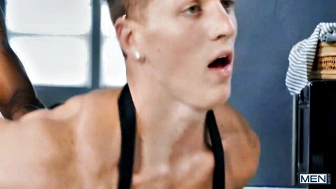 Felix Fox bent over moaning as Slim Saint grips him in interracial gay anal scene