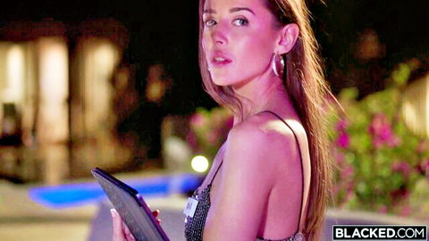 Sybil in sexy sparkling dress holding tablet outdoors at night