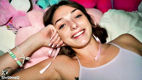 Shrooms Q smiling playfully in bed, teasing for her first anal adventure