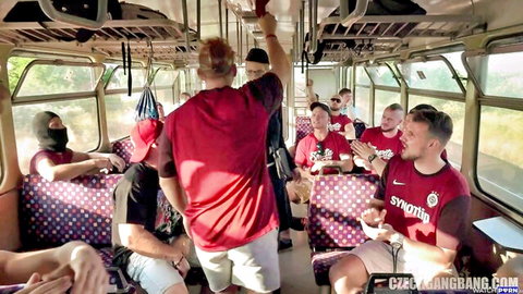 Masked men in red jerseys crowd polka-dot train seats for Czech gangbang public sex