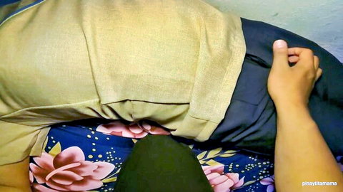 Asian babe on floral bed with man's hand groping her pussy over yellow pants