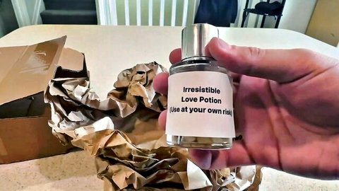 Hand holding irresistible love potion bottle in box for wild seductive fucks