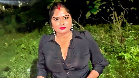 Sexy Indian woman in deep cleavage black blouse outdoors at night