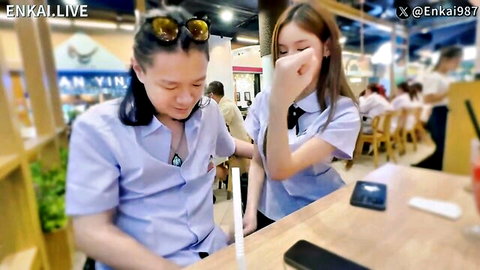 Thai model Enka in student cosplay uniform at cafe table