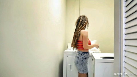 Indica Flower teasing in red tube top and denim shorts at laundry