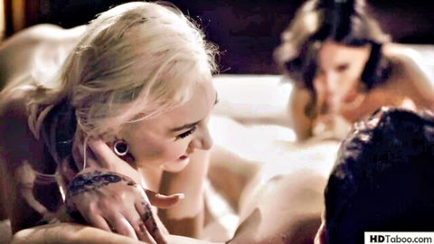 Nude blonde with tattoos and brunette babe teasing man in taboo threesome bed romp