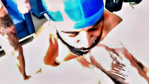 Bearded man in blue cap in wet sling pose, intense adult action