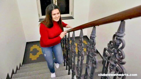 Sereyna Gomez smiling brunette teen in red sweater and jeans climbing stairs