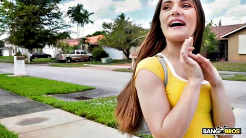 Juniper Ren smiling in yellow dress outdoors, teasing vibe