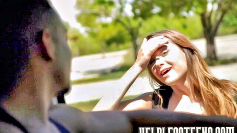 Alex Mae smiling seductively in car with red hair and tank top