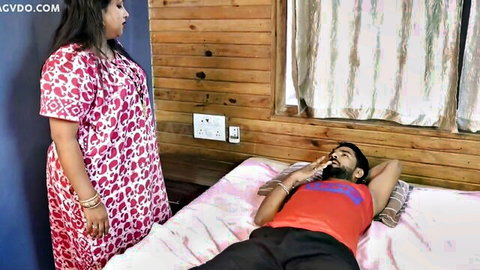 Bindu Thakur as step aunty in red dress standing over man on bed