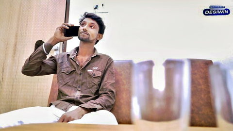 Desi man on phone call in casual attire, brown shirt white pants