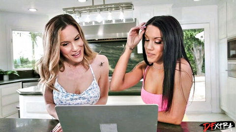 Nina White and brunette friend leaning over laptop in kitchen tops