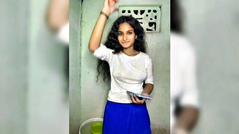 Tamil girl Khadija37 smiling in white top and blue skirt, bathroom tease
