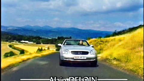 Silver Mercedes convertible cruising scenic mountain road in Collector 1999