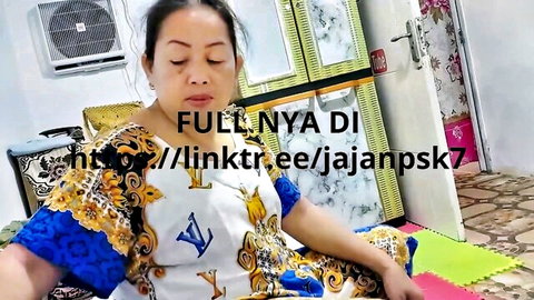 Indonesian mature woman in colorful LV dress posing seductively