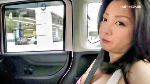 Minako in low-cut white dress showing cleavage in BMW car