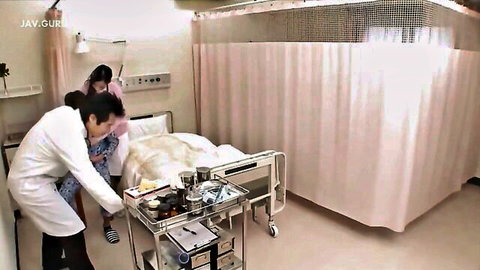 Japanese male nurse bends over fingering patient's pussy under hospital sheet with assistant nearby