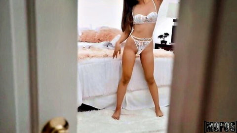 Alexia Anders in white lace lingerie, seductive bedroom pose
