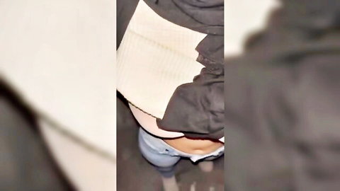POV upskirt of woman with jeans pulled down exposing tight white panties and bare navel