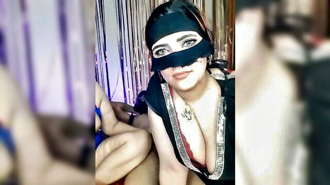 Veiled Arab woman with huge cleavage spreads legs wide in shiny black top teasing big tits