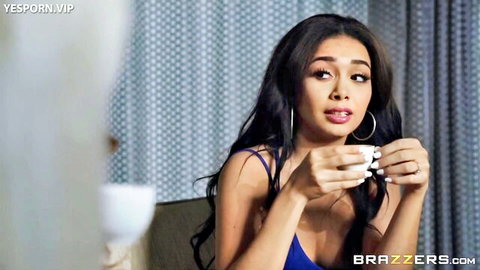 Aaliyah Hadid in sexy blue slip dress, holding teacup with cleavage tease