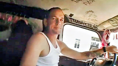 Muscular Caucasian man in white tank top driving bus for steamy encounter
