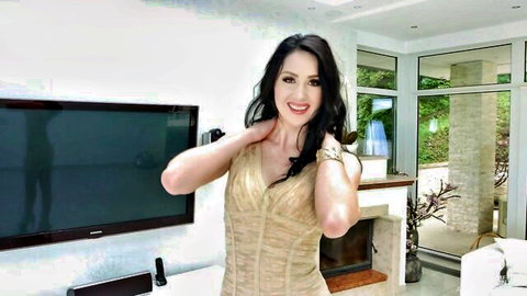 Meri Kris in sexy gold dress, smiling seductively in solo tease