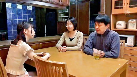 Slender Asian girl in off-shoulder top with mature couple at table