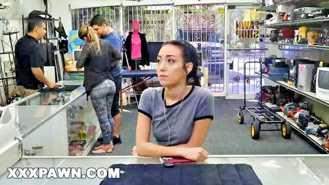 Petite brunette teen with small tits in tight leggings sits at pawn shop counter teasing cameltoe