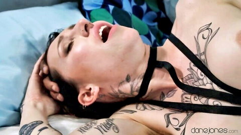 Tattooed alt babe in black harness choker, mouth open in pleasure, kinky BDSM with ebony boyfriend