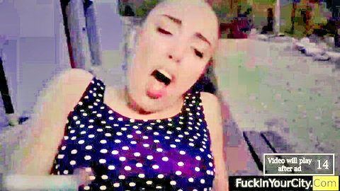 Eva Elfie teasing with open mouth and tongue out in polka dot tank top